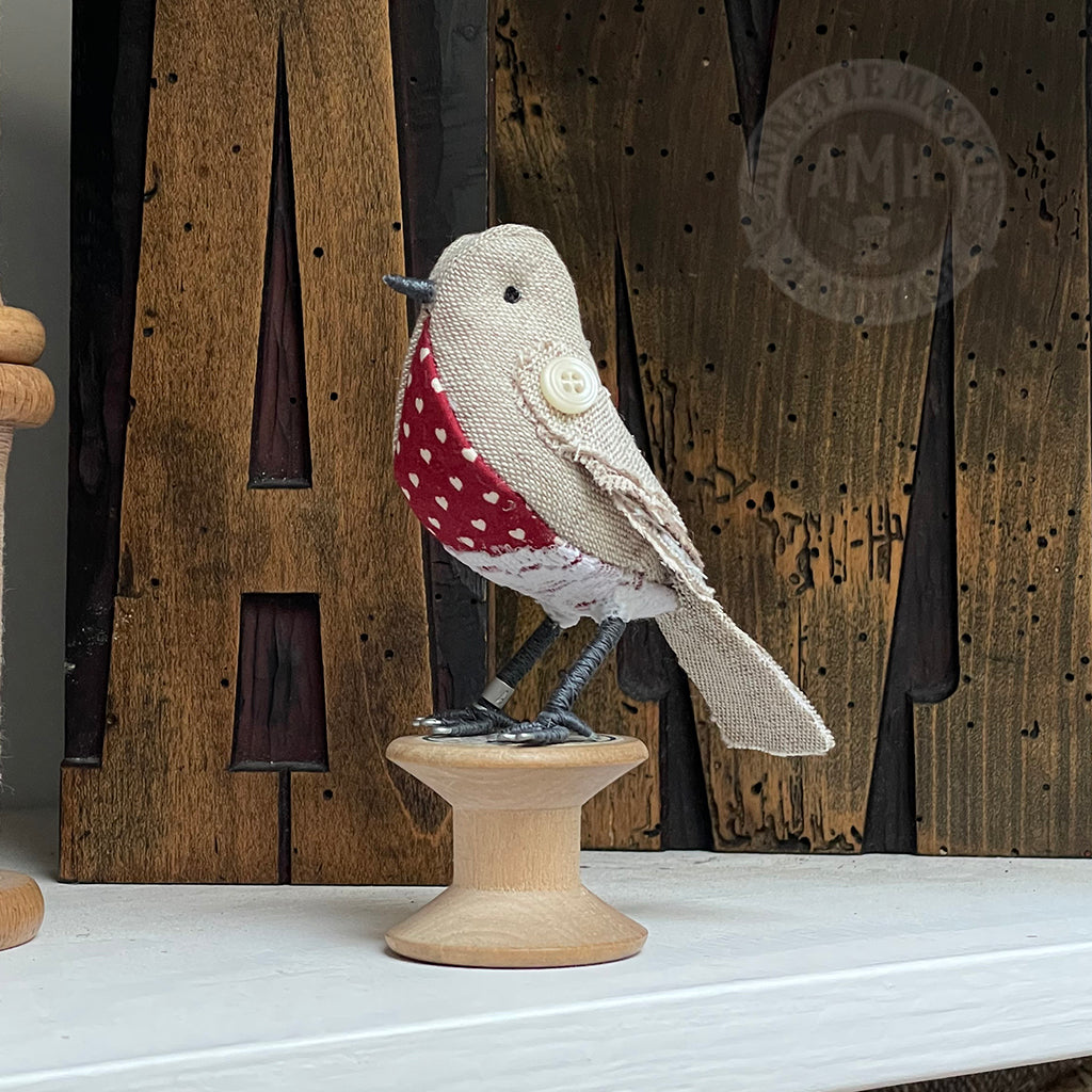 Mini bird on vintage reel