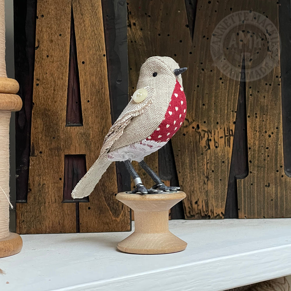 Mini bird on vintage reel