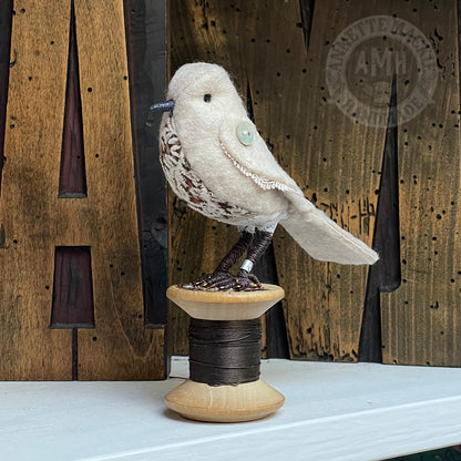 Mini bird on vintage reel