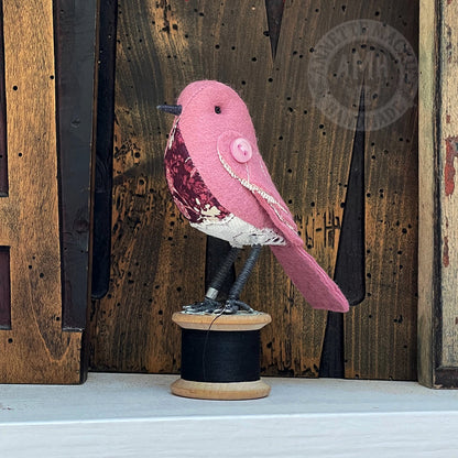 Mini bird on vintage reel