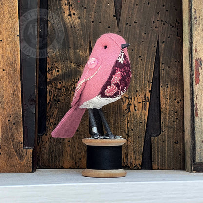 Mini bird on vintage reel