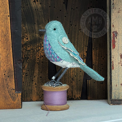 Mini bird on vintage reel