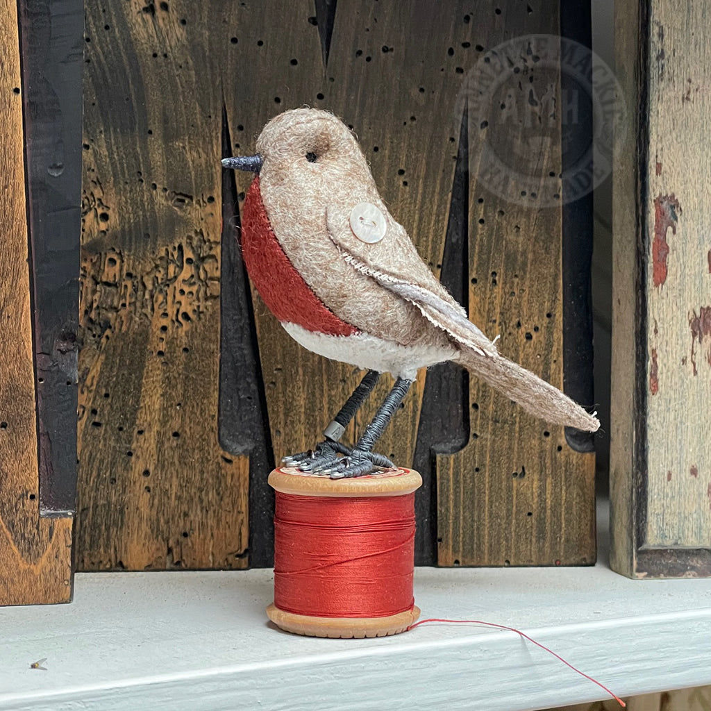 Mini bird on vintage reel