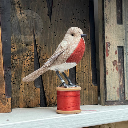 Mini bird on vintage reel