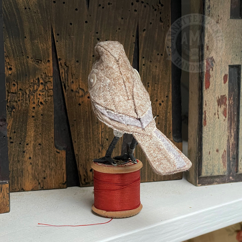 Mini bird on vintage reel