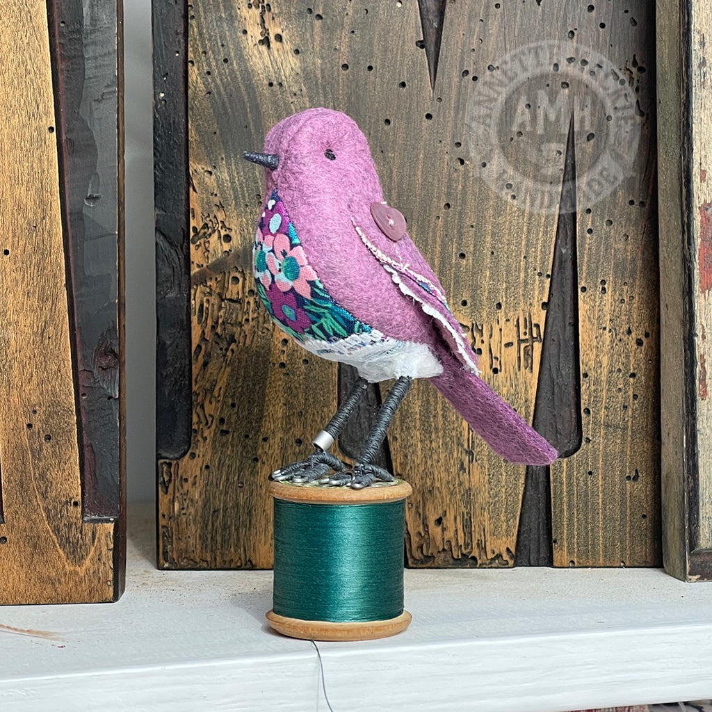 Mini bird on vintage reel