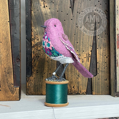 Mini bird on vintage reel