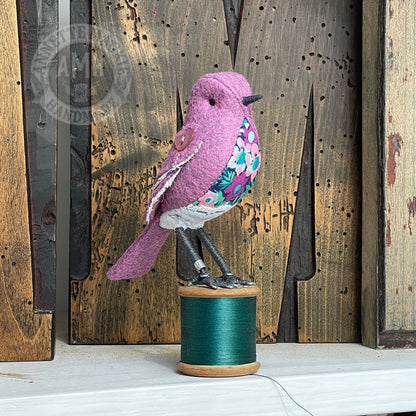 Mini bird on vintage reel