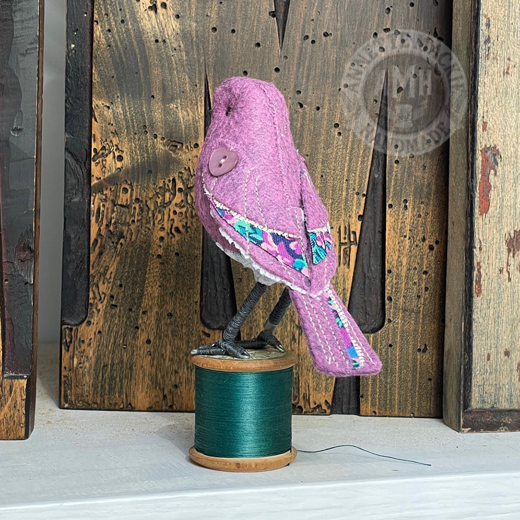 Mini bird on vintage reel