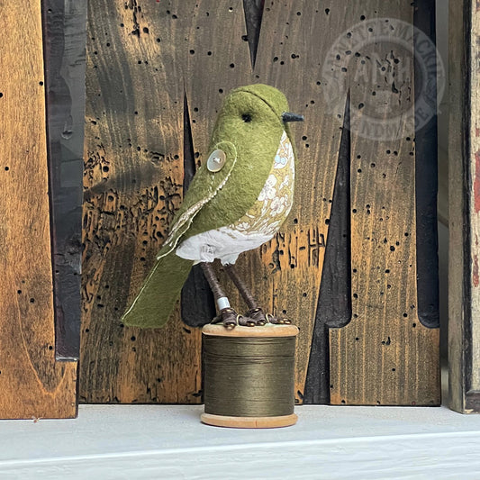 Mini bird on vintage reel