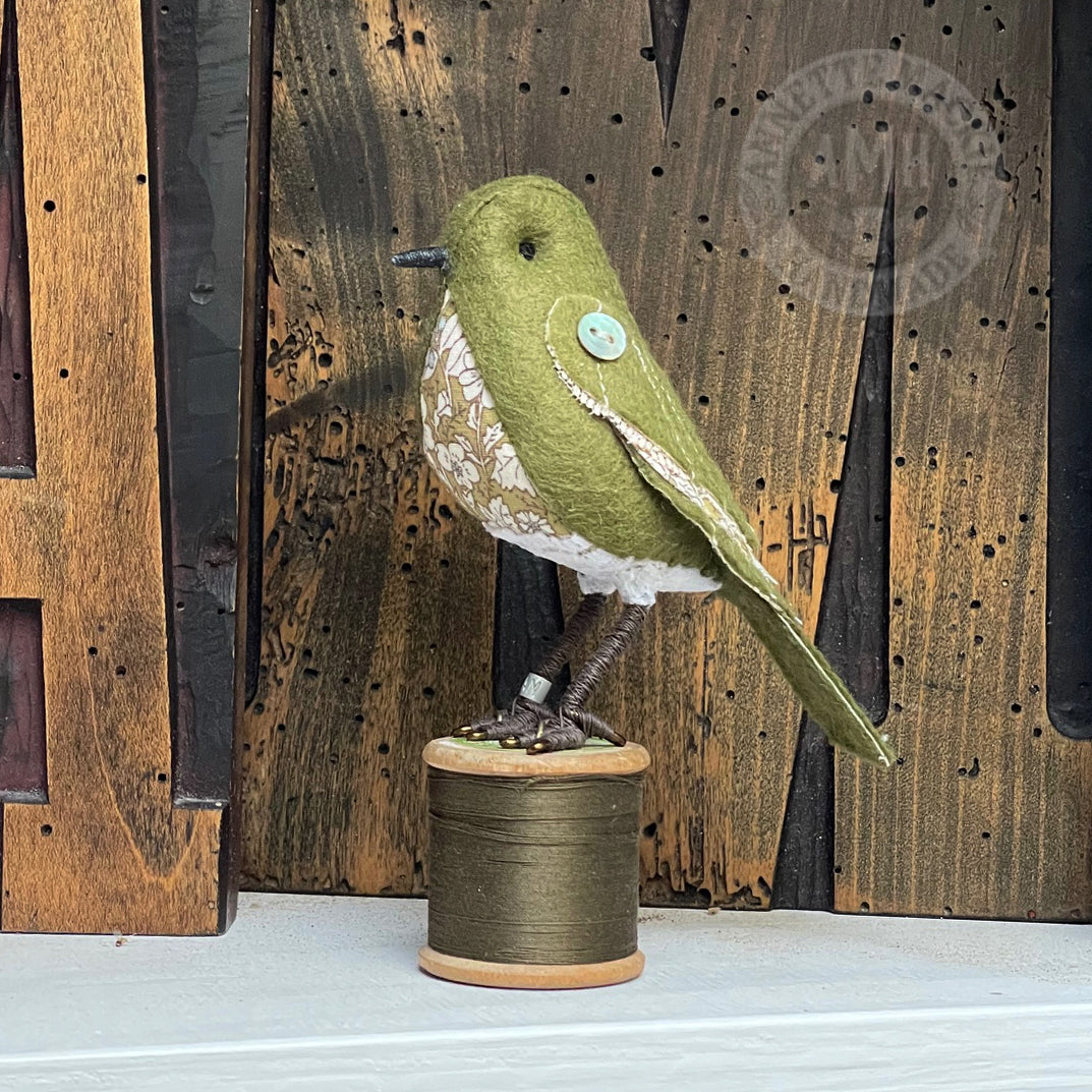 Mini bird on vintage reel