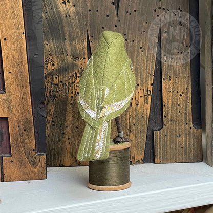 Mini bird on vintage reel