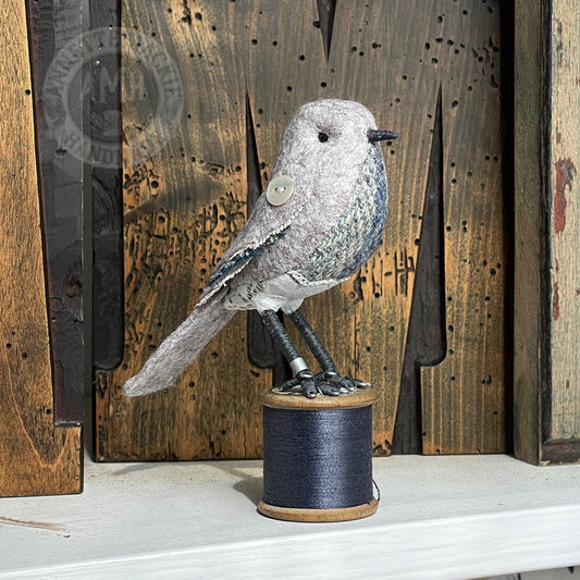 Mini bird on vintage reel