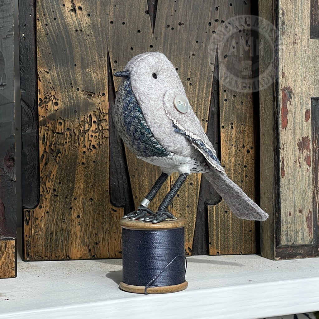 Mini bird on vintage reel
