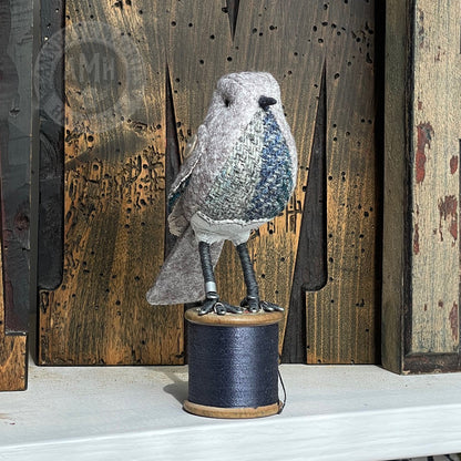 Mini bird on vintage reel