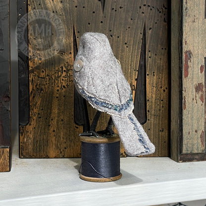Mini bird on vintage reel