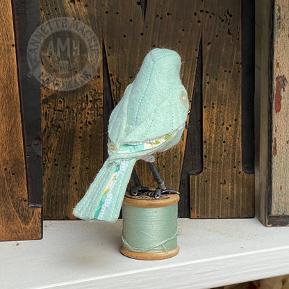 Mini bird on vintage reel