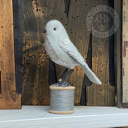 Mini bird on vintage reel