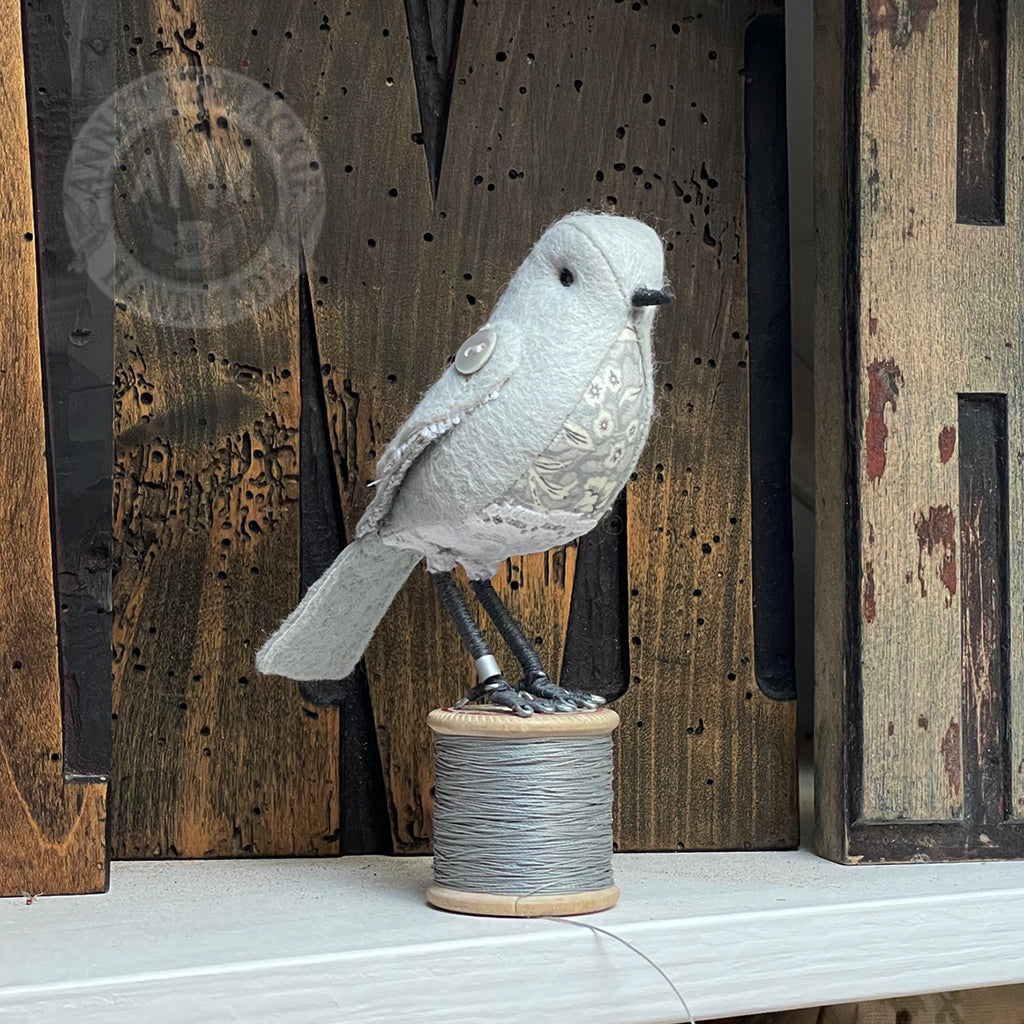 Mini bird on vintage reel