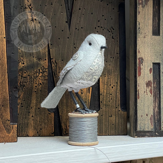 Mini bird on vintage reel
