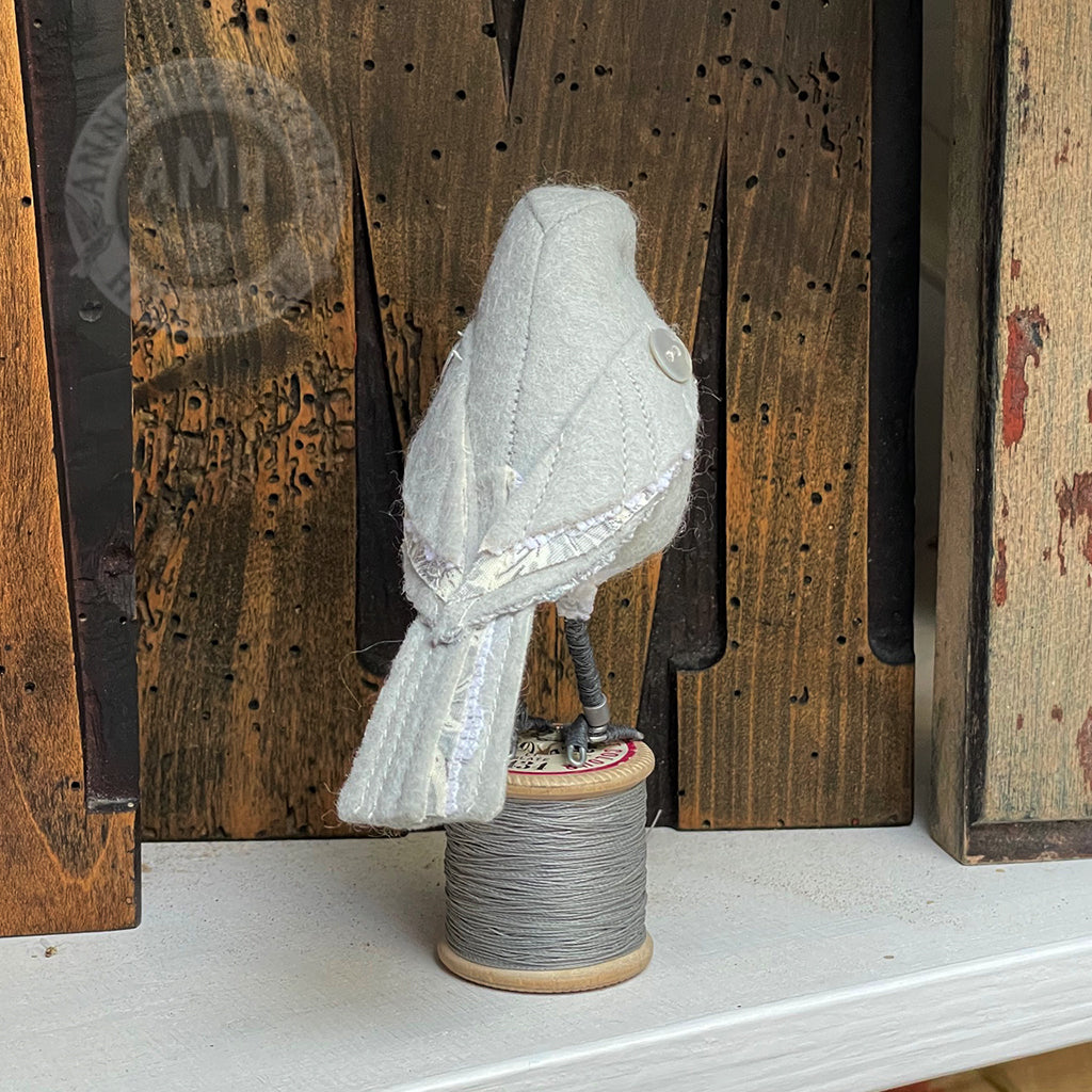 Mini bird on vintage reel