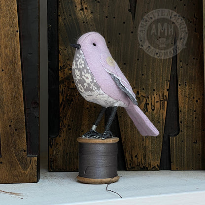 Mini bird on vintage reel