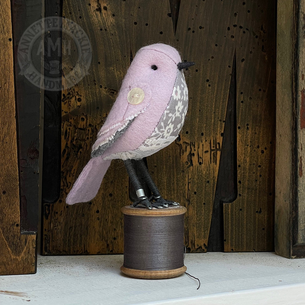 Mini bird on vintage reel