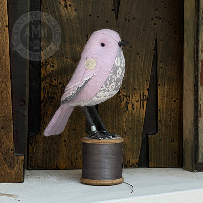 Mini bird on vintage reel