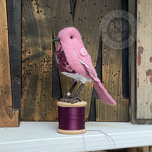 Mini bird on vintage reel