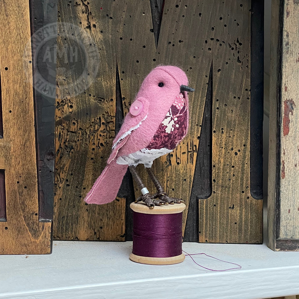 Mini bird on vintage reel