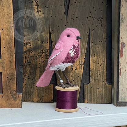 Mini bird on vintage reel