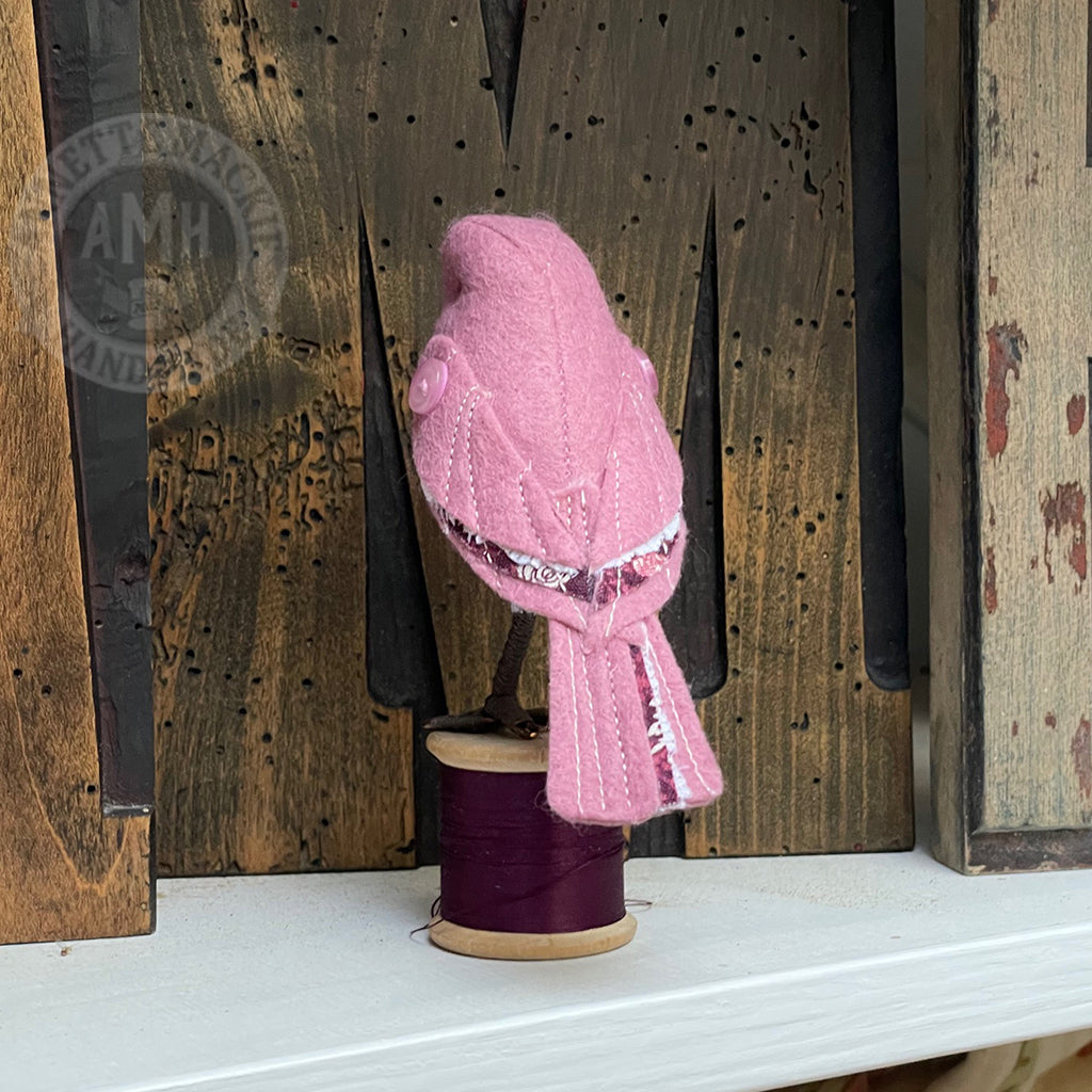 Mini bird on vintage reel