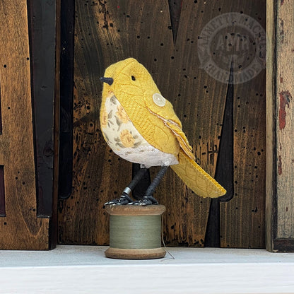 Mini bird on vintage reel