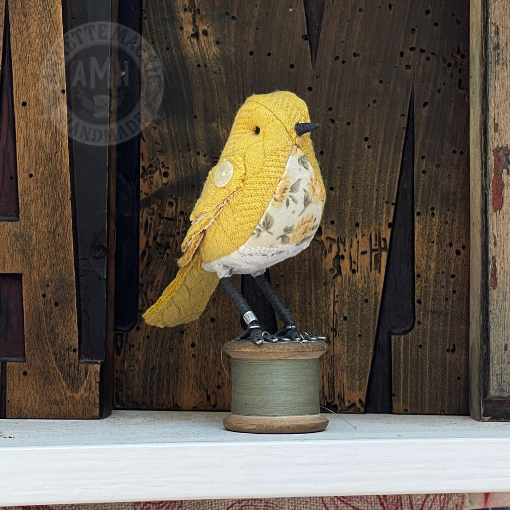 Mini bird on vintage reel