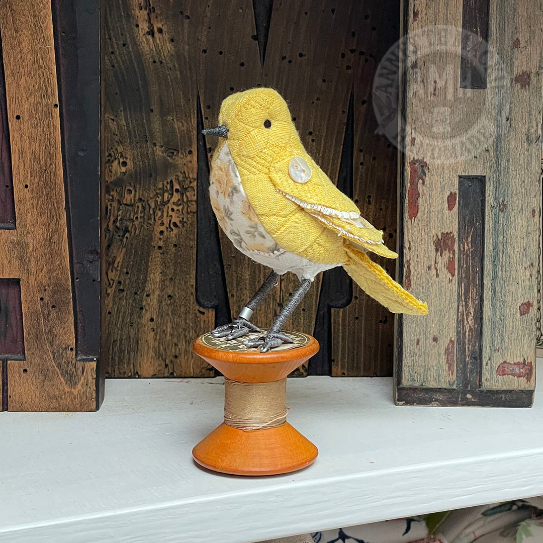 Mini bird on vintage reel